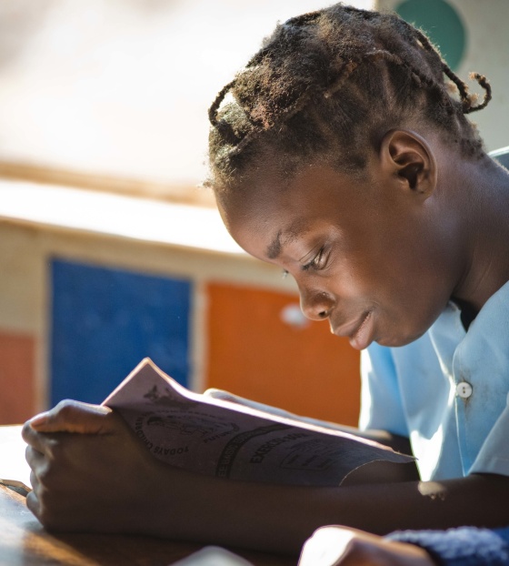 Girl reads book in Liberia