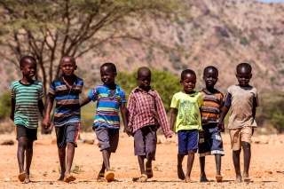 Children walk together holding hands