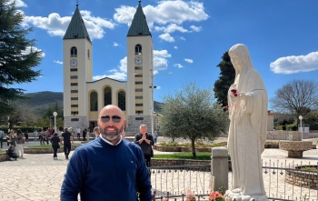 A man in front of the St. James' Church in Medjugorje