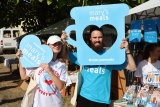Two people posing with Mary's Meals props at Mladifest 2024. 