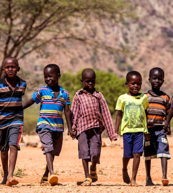 Children walk together holding hands