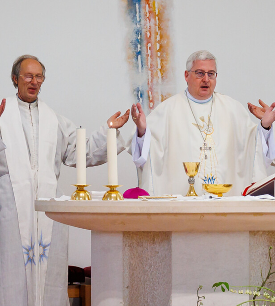 Priests praying during mass.