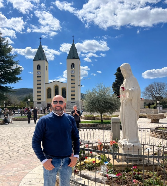 A man in front of the St. James' Church in Medjugorje