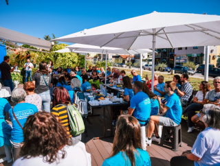 Large group of people gathered at the Blue Container. 