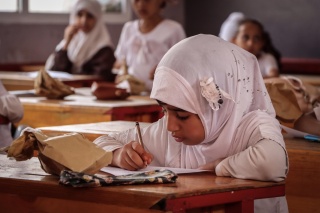 Child writing in class