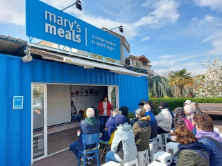 People gathering for a film screening at the Blue Container.