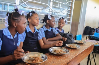 Girls receiving school meals in Haiti